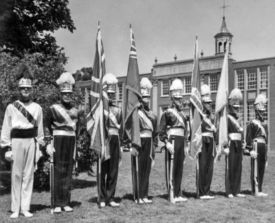 Publicity shot showing the Drum Major (Phil Hennings) and the Guard (in front of De La Salle Oaklands, 1958)
Submitted by Jim Patten
Keywords: 1958