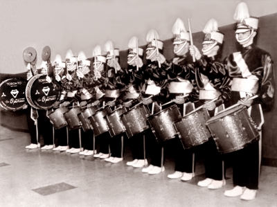 Toronto Optimists Big Drumline (Maple Leaf Gardens, 1960)
6 snares plus 3 tenors was a very big drumline in 1960! Most corps carried 3 & 3.

L-R: Glen Durish, Glenn Copp, Hector Roberts, Colin Hedworth, Carl Clutchey, Gord O'Halloran, Jim Reynolds, Bob Anderson, Bill Ukas, Brian Williams, Ronn Prokop, Harry Clark

From Colin Hedworth's collection
Keywords: 1960