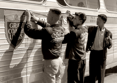 Glenn Copp, Glen Durish ? and Kenny Nakagawa putting the Optimists banner on the bus (1960)
Photo by Don Daber
Keywords: 1960