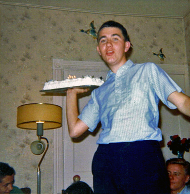 Doug Mackenzie with Mike Thys on left and George Wright in back (1964 or '65)
The photo was taken at Don Norman's (guard) house after the 64 or 65 nationals, his mom had baked the cake to celebrate our winning. 

Submitted by Doug Mackenzie
Keywords: 1964 1965