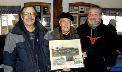 Peter Barclay, Ernie Christie & Vern Johansson at our Open House (Welland, 2010)
Photo by Eric McConachie

Ernie is the father of Bob and John Christie who marched with the Toronto Optimists. The photo montage that Ernie is holding includes 2 photos taken during 1967 showing the Optimists performing in Ernie's back yard in Welland.  Ernie religiously drove his sons and a bunch of other guys all the way to Toronto for rehearsals and his dedication allowed these guys to march with the Optimists. Peter Barclay, Bob & John Christie, Dave & Brian Byrne and Dennis Roberts are just some of the guys who were helped by this great chauffeur!
Keywords: 2010