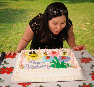 Yun blows out candles on her birtday cake (BBQ, 2018)
Photo by David Johns
Keywords: 2018