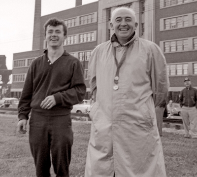 Doug McPhail and Bernie Beer (Toronto Waterfront, June 25, 1961)
Photo by Don Daber

An impressive award ceremony was a scene on the field at the waterfront docks under cloudy skies as the Toronto Optimists presented their Golden-Green Compass Award. The Award was present by the corps' drill instructor, Doug McPhail, to Mr Bern Beer, Co-Director of the corps, in recognition of his outstanding services in directing the corps' bus 30 miles along the wrong route during a recent trip to Phillipsburg, NJ. (from GCC)
Keywords: 1961