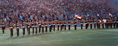 Seneca Optimists (1977)
Does anyone remember anything about this show? The corps is in their t-shirts and it looks like they're carrying Seneca College flags as well as Toronto Argonaut flags.  Presumably, it was at an Argo game.

Photo submitted by Mark Decloux
Keywords: 1977