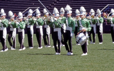 Toronto Optimists (Nationals Prelims, Varsity Stadium, Toronto, 1964)
This was taken during the "Yankee Doodle" segment of "It's Legitimate". Jeff Shimo is holding his horn sideways to mimic the fife.

Photo by Don Daber
Keywords: 1964