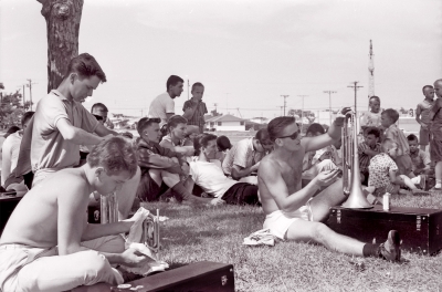 Toronto Optimists polishing our brass horns before the contest (Racine, WI, 1964)
Bill Hannah by the tree, followed by George Wright, Terry McKolskey, Bill Grigg (behind Terry), Glenn Rawson, probably Mike Thys, John Kubicz cleaning his horn and John Diamond looking over his right shoulder. Joe Palanica is front left.

Photo by Don Daber
Keywords: 1964